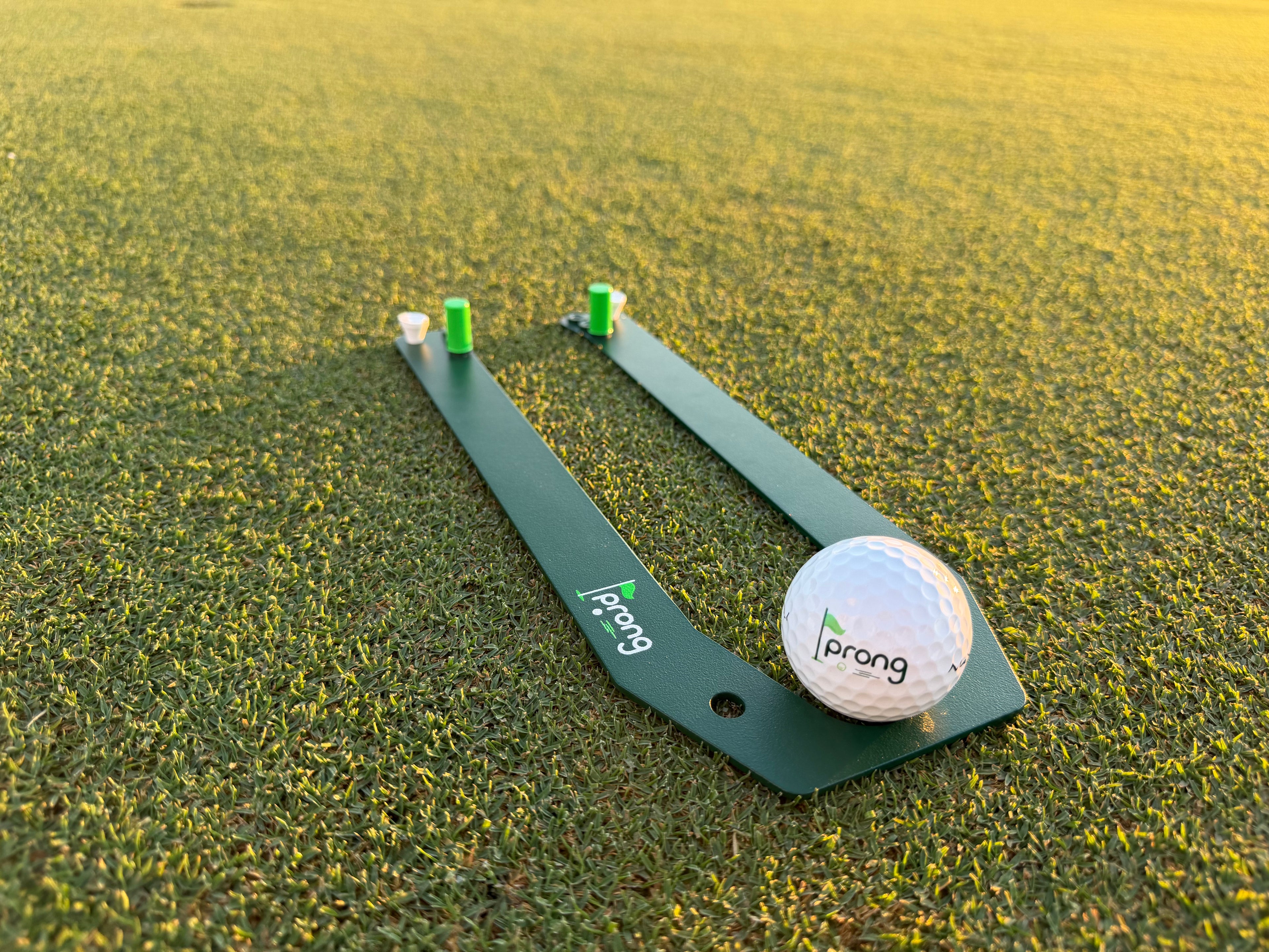 A golf ball and putting tool-prong
